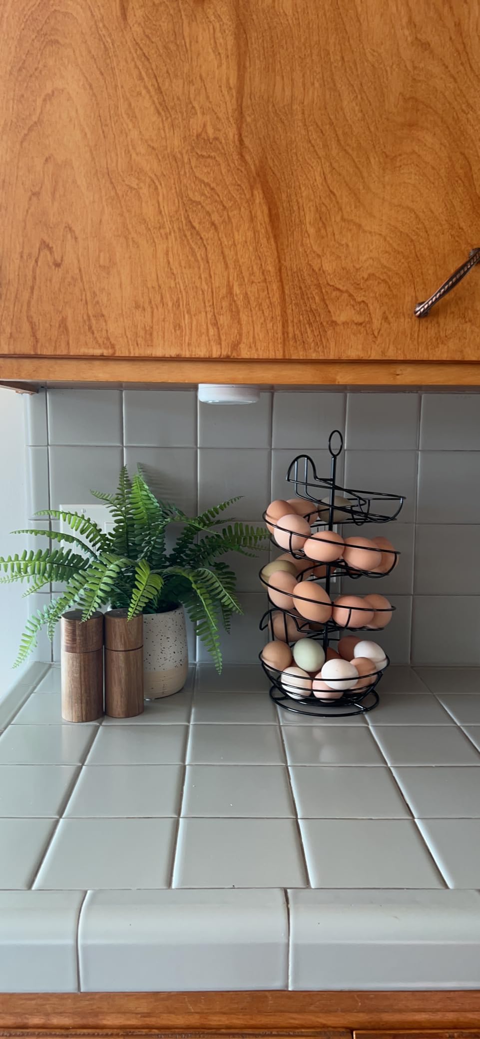 QUTREY Black Metal Egg Holder Countertop, Fresh Egg Skelter, Spiral Design Egg Dispenser Rack with Storage Basket for Display Easter Eggs customer photo 1